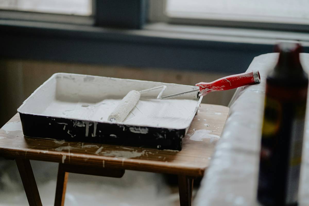 diy home design projects featuring a hand sanding a wooden shelf before painting