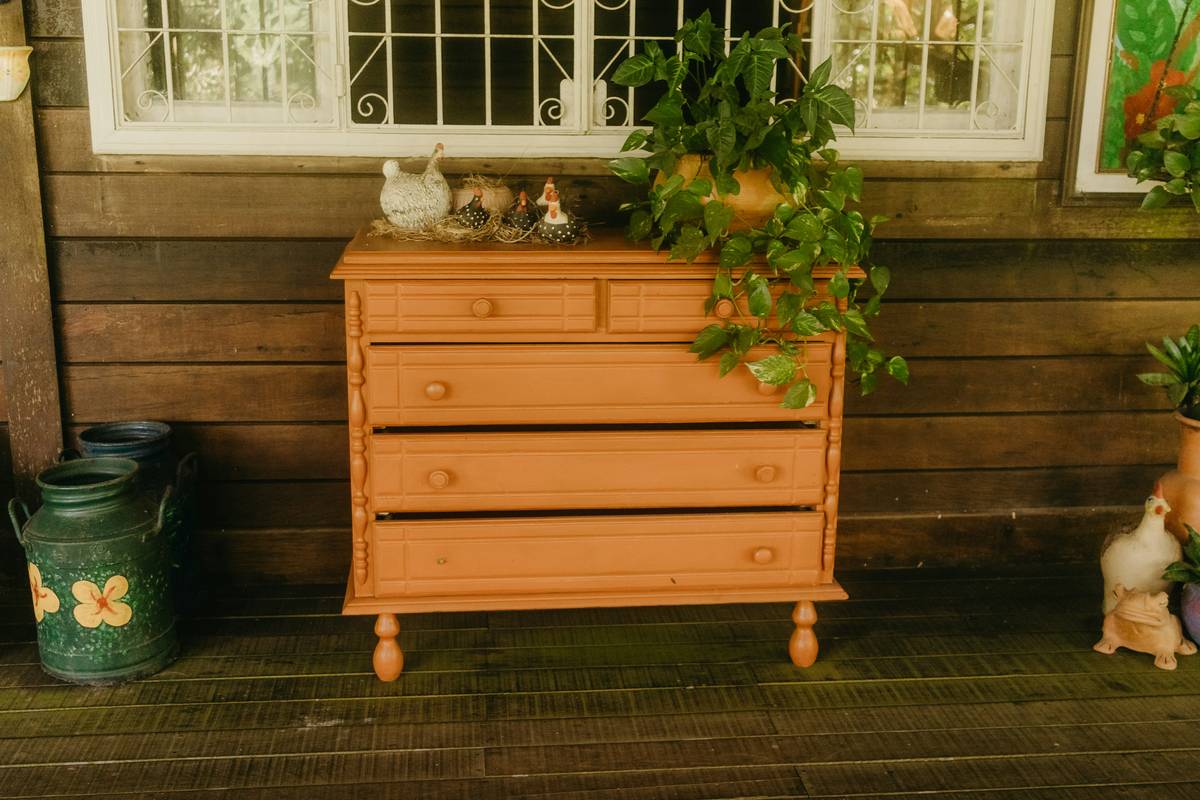 A rustic wooden shelf holding handmade ceramic vases and dried florals as a style find diy project unique idea